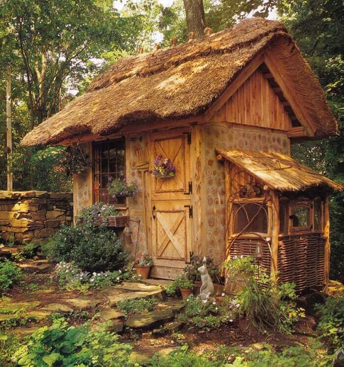 Whimsical Thatched Potting Shed with Rabbit Hutch on Side