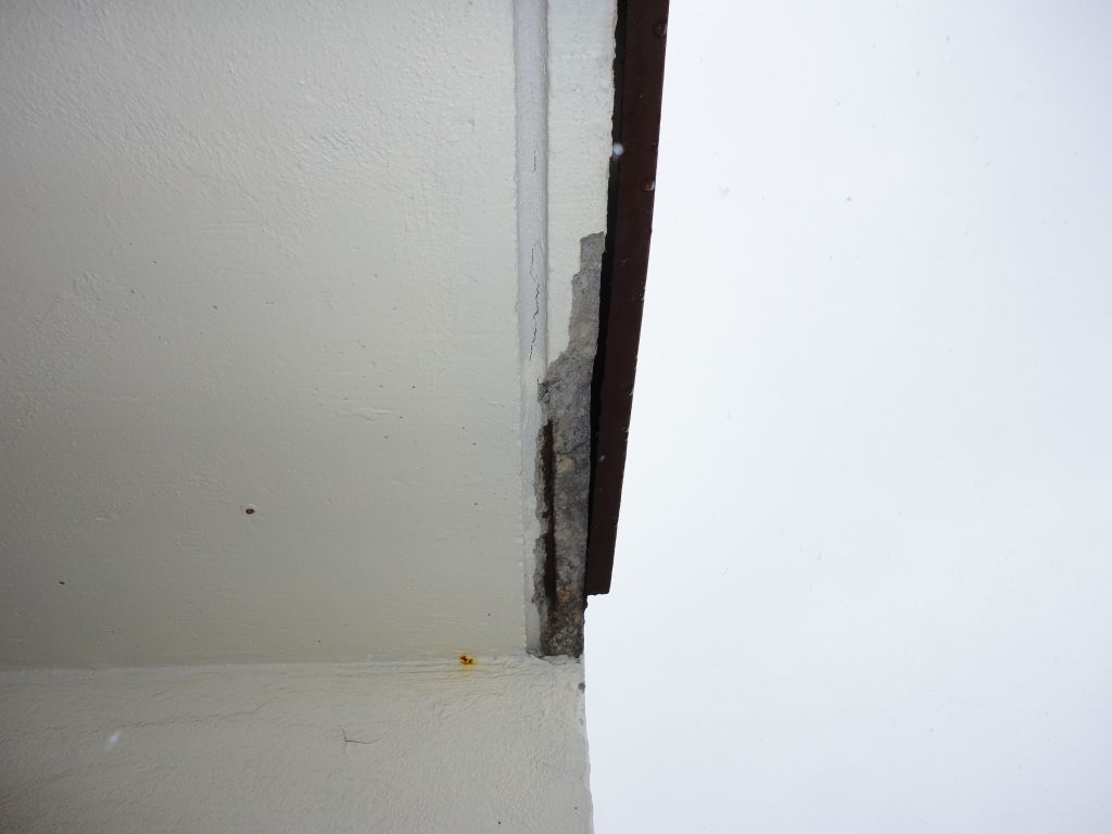 This photo shows the drip slot running parallel to the slab edge. The steel placed too close to the drip slot has corroded, and the concrete has fallen off. If the steel had been placed higher in the slab or further towards the building wall, this failure would not have occurred. Building maintenance personnel should be alert to fine cracks in the drip slot as these are typically a warning that loose concrete is developing. For safety reasons it should be removed before it falls, potentially causing injury. 